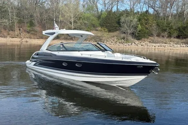 Slide: The Image of 2026 Formula 330 Crossover Bowrider I/O on calm water, surrounded by trees. - 25