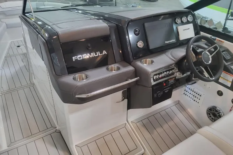 Slide: The Image of 2026 Formula 330 Crossover Bowrider I/O dashboard with steering wheel and controls. - 4