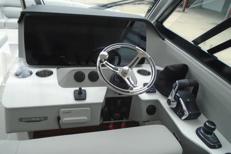 Slide: The Image of 2026 Regal LX36 boat cockpit with steering wheel, controls, and navigation display. - 15