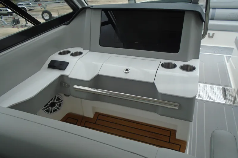 Slide: The Image of 2026 Regal LX36 boat interior with cup holders and sleek dashboard design. - 16
