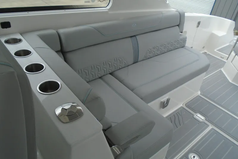 Slide: The Image of Luxurious seating area on the 2026 Regal LX36 boat with cup holders and sleek design. - 20