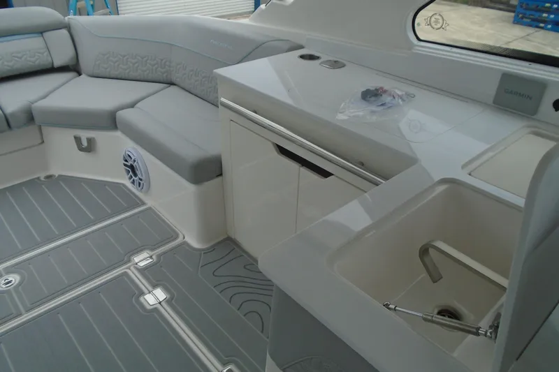 Slide: The Image of Luxurious interior of 2026 Regal LX36 boat with seating and kitchenette. - 21