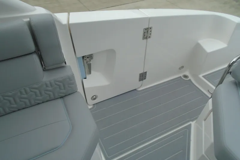 Slide: The Image of Interior view of 2026 Regal LX36 boat, featuring sleek gray seating and flooring. - 23