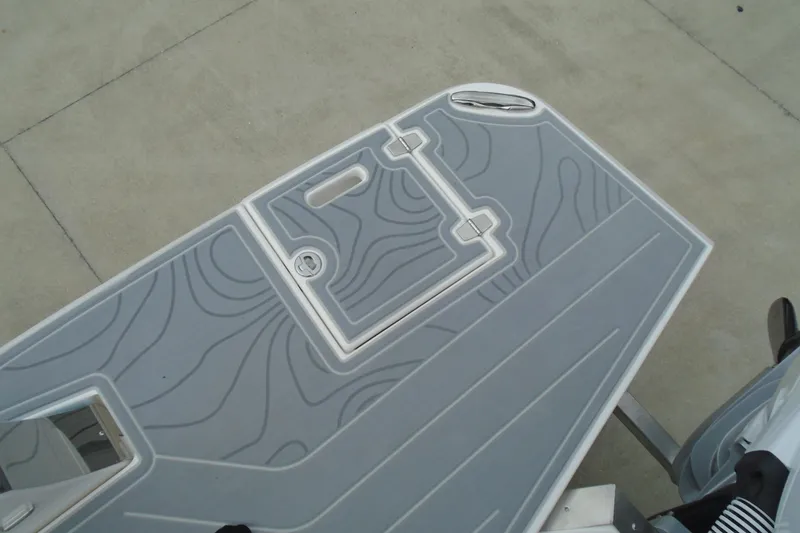 Slide: The Image of 2026 Regal LX36 boat deck with textured gray surface and hatch. - 25