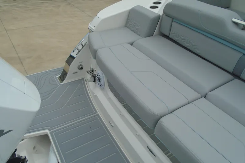 Slide: The Image of 2026 Regal LX36 boat with sleek gray seating and modern design. - 26