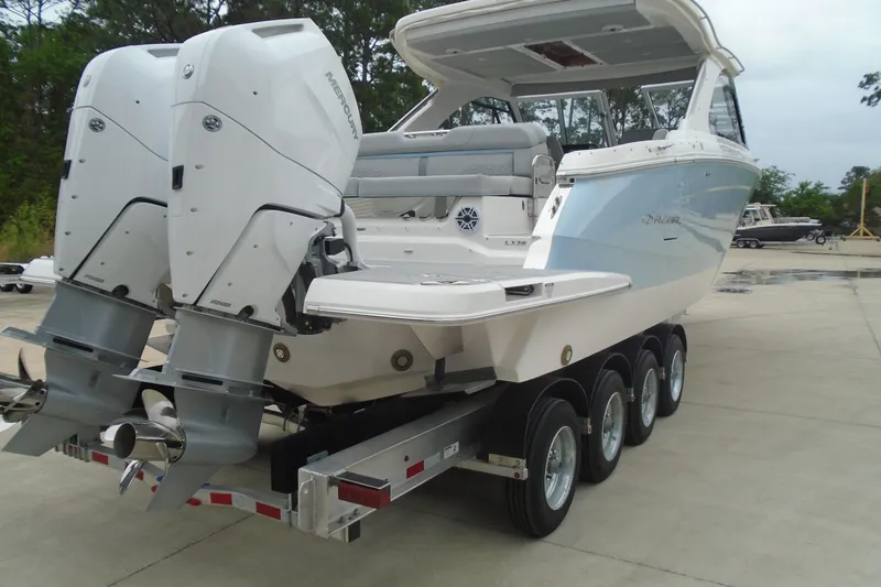 Slide: The Image of 2026 Regal LX36 boat on trailer with dual outboard engines. - 9