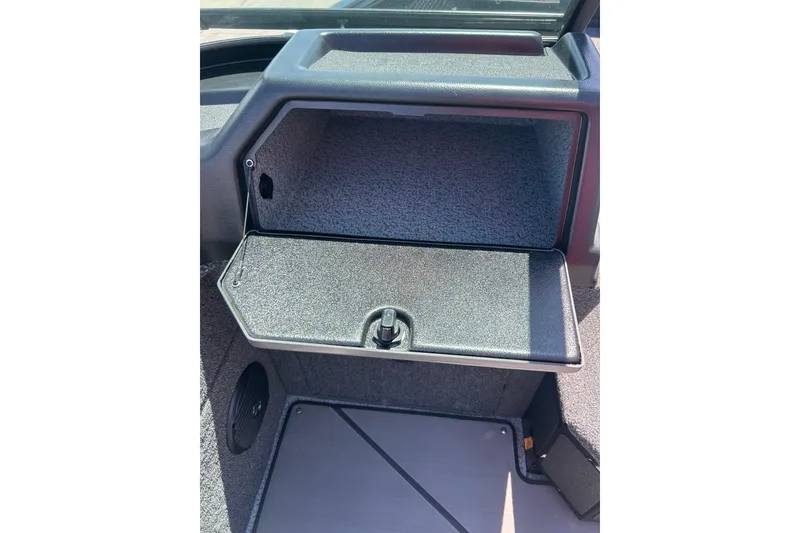 Slide: The Image of 2026 Lund 1875 Impact XS Sport boat storage compartment, open and empty. - 11