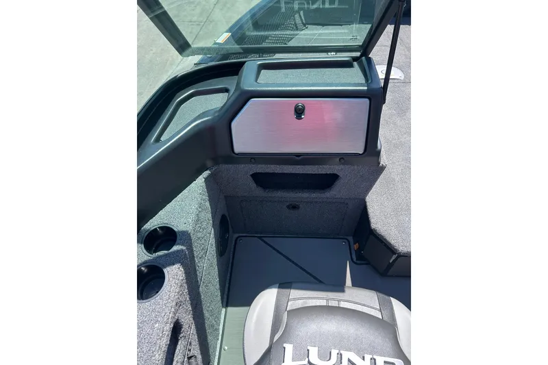 Slide: The Image of 2026 Lund 1875 Impact XS Sport boat interior with storage compartment and seating. - 13