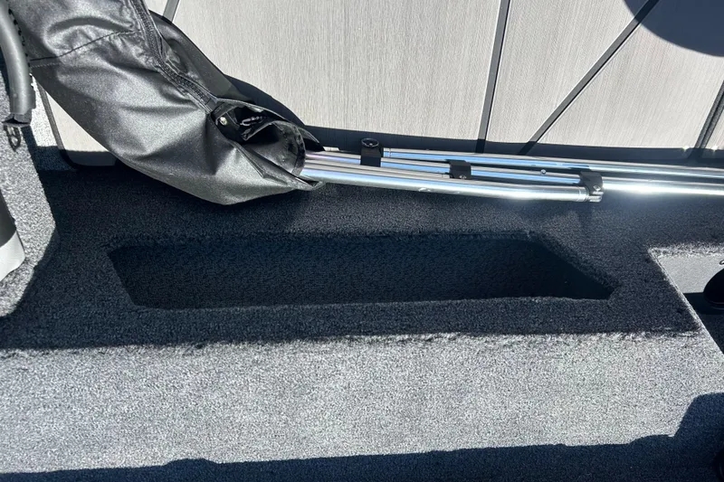 Slide: The Image of Interior view of 2026 Lund 1875 Impact XS Sport boat, featuring storage compartment and equipment. - 14