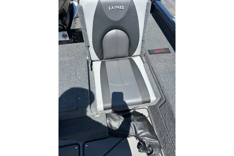 Slide: The Image of 2026 Lund 1875 Impact XS Sport boat seat, gray and black upholstery, close-up view. - 16
