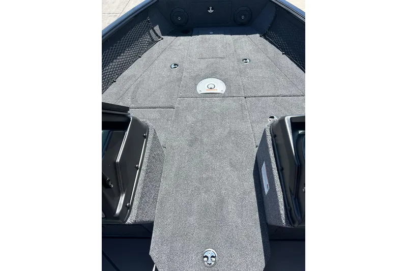 Slide: The Image of 2026 Lund 1875 Impact XS Sport boat interior with gray carpeted deck. - 17