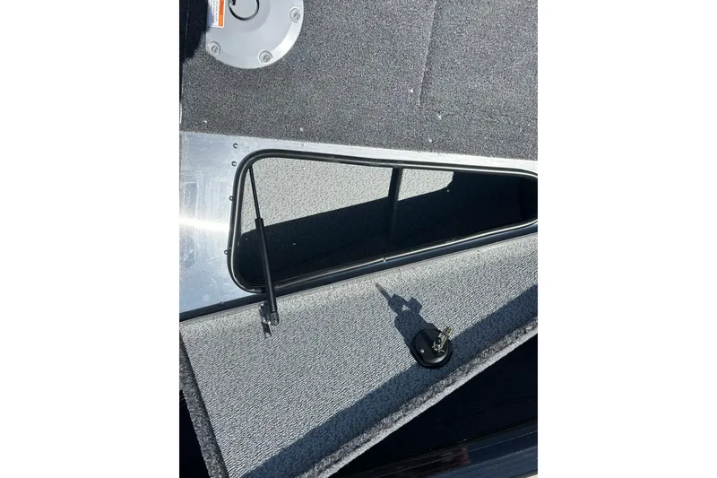Slide: The Image of Open storage compartment on 2026 Lund 1875 Impact XS Sport boat deck. - 19