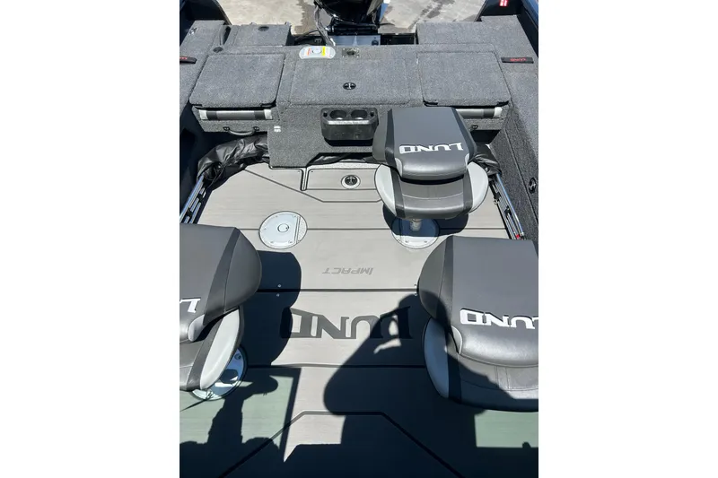 Slide: The Image of 2026 Lund 1875 Impact XS Sport boat interior with branded seating and storage compartments. - 24