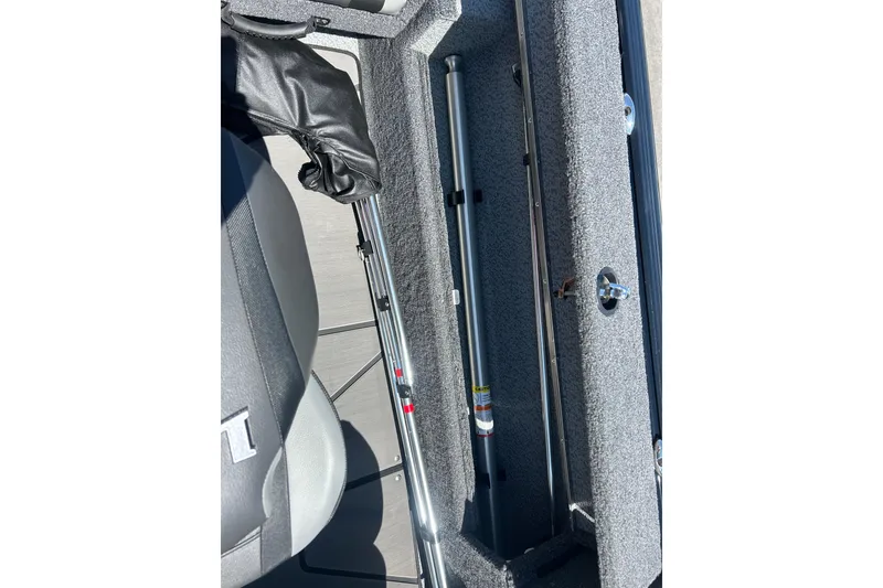 Slide: The Image of Interior view of 2026 Lund 1875 Impact XS Sport boat storage compartment. - 27