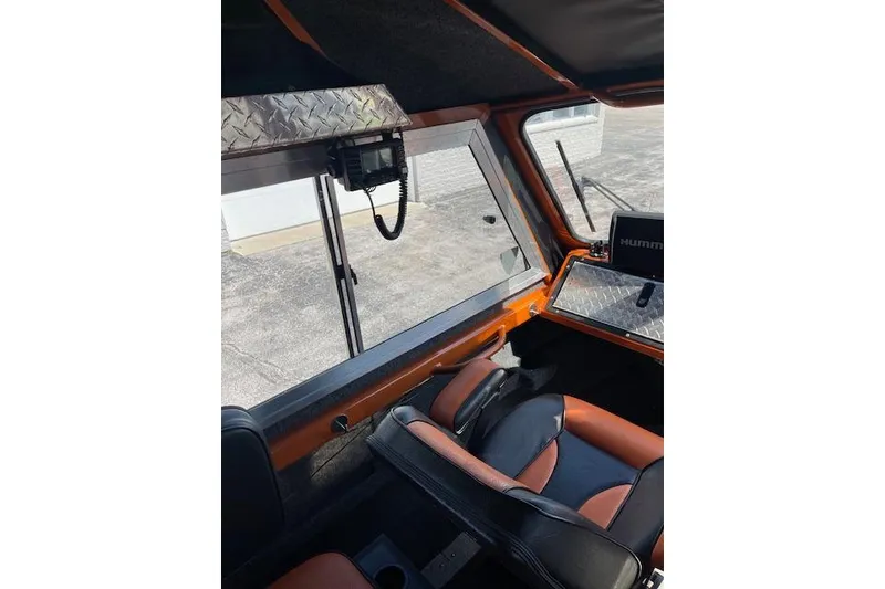 Slide: The Image of Interior of a 2018 Thunder Jet Luxor Limited boat with modern controls and seating. - 10