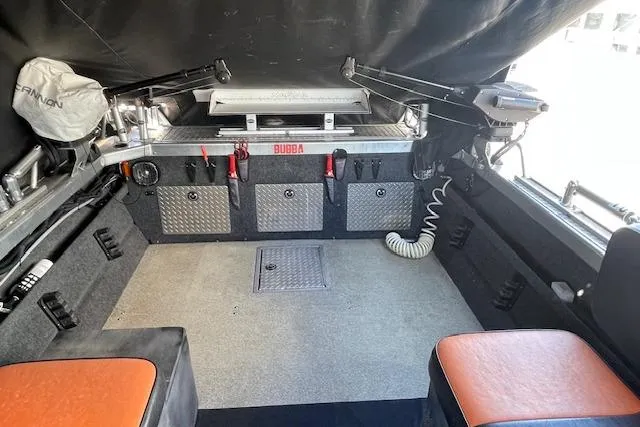 Slide: The Image of Interior of a 2018 Thunder Jet Luxor Limited boat with storage compartments and seating. - 12