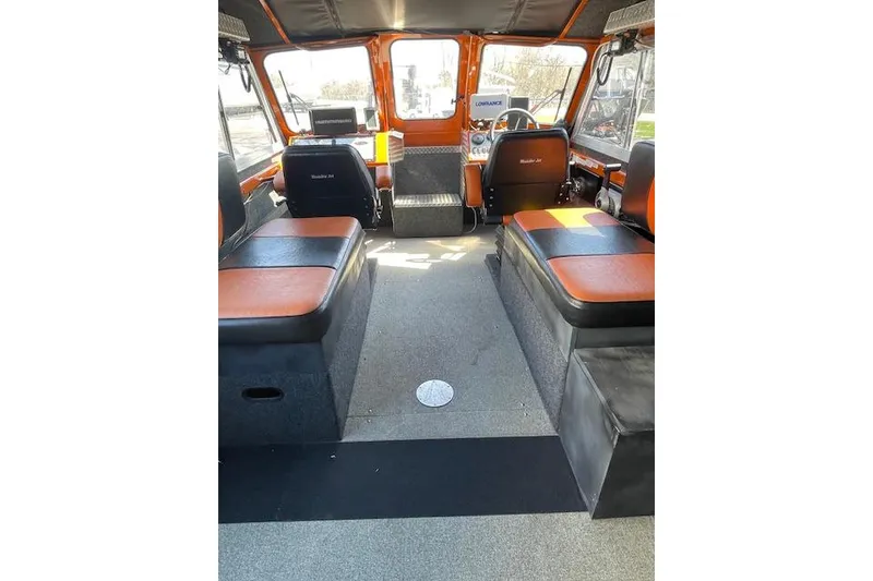 Slide: The Image of 2018 Thunder Jet Luxor Limited boat interior with orange and black seating. - 14