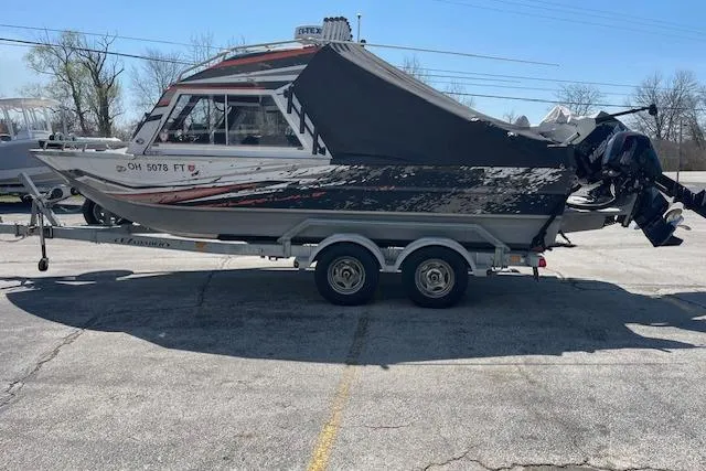 Slide: The Image of 2018 Thunder Jet Luxor Limited boat on trailer, parked outdoors. - 2