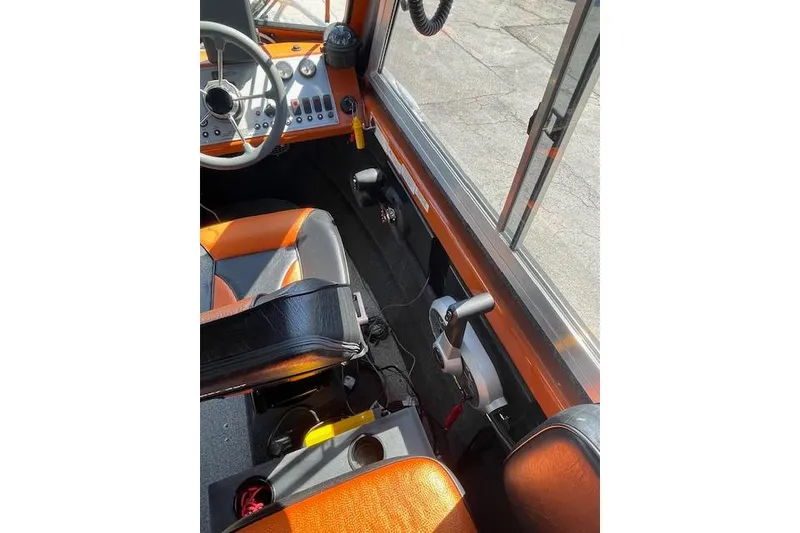 Slide: The Image of Interior of a 2018 Thunder Jet Luxor Limited boat, featuring steering controls and seating. - 7