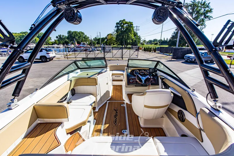 Slide: The Image of 2016 Sea Ray SPX 190 boat interior with tan seating and sleek dashboard. - 10