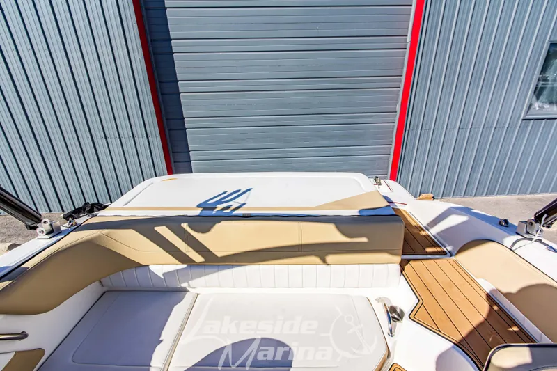 Slide: The Image of 2016 Sea Ray SPX 190 boat interior with beige seating and wooden deck accents. - 11