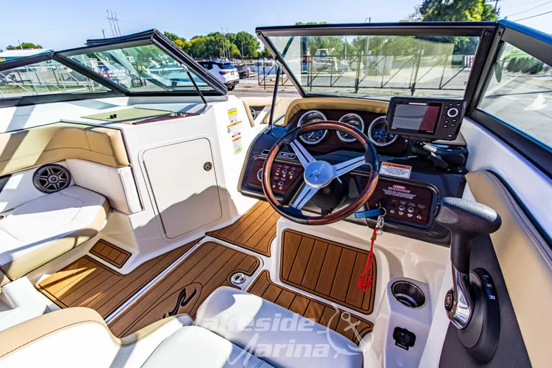 Slide: The Image of 2016 Sea Ray SPX 190 boat interior with steering wheel, dashboard, and seating. - 16