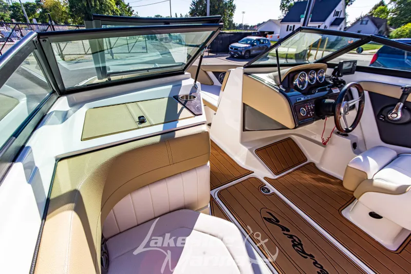 Slide: The Image of Interior of 2016 Sea Ray SPX 190 boat with tan seating and wood-style flooring. - 19
