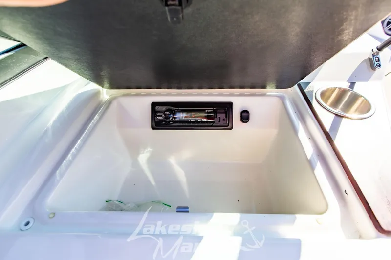 Slide: The Image of Storage compartment with audio system in 2016 Sea Ray SPX 190 boat. - 20