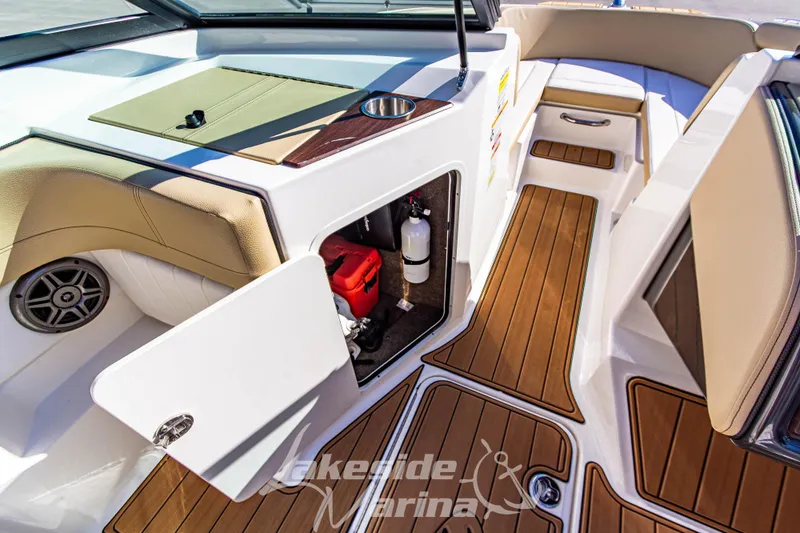 Slide: The Image of 2016 Sea Ray SPX 190 boat interior with open storage compartment and teak flooring. - 23