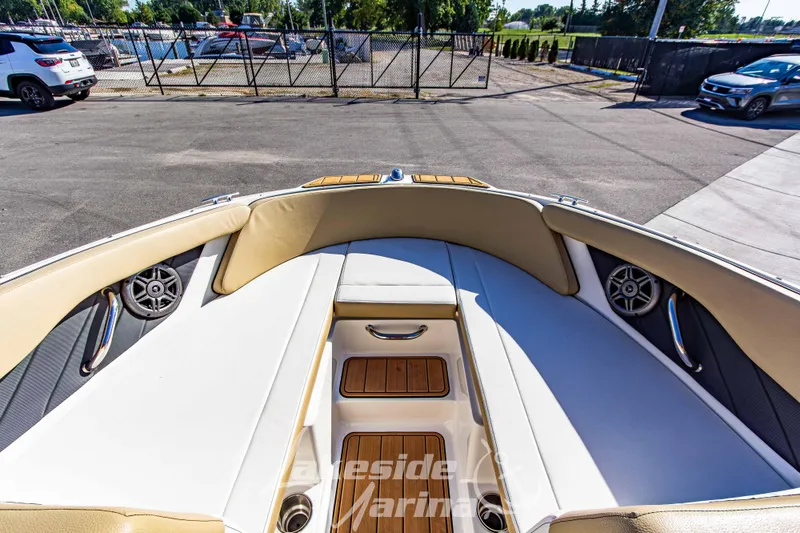 Slide: The Image of 2016 Sea Ray SPX 190 boat interior with beige seating and wood accents. - 24