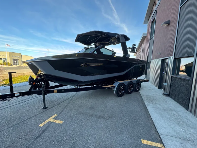 The Image of 2025 Nautique G23 boat on trailer outside building. - 1