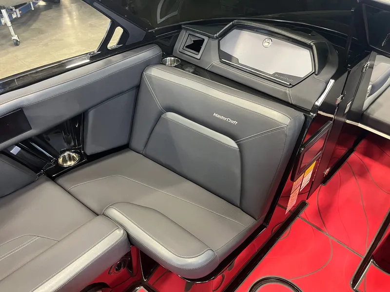 Slide: The Image of Interior of 2022 MasterCraft XStar S with gray seats and red flooring. - 11