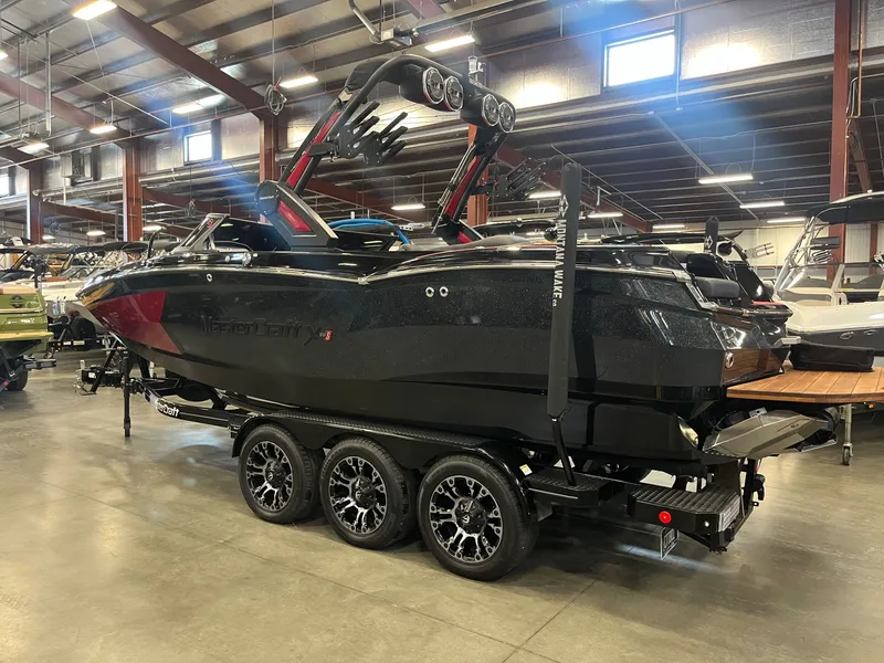 Slide: The Image of 2022 MasterCraft XStar S boat in a warehouse setting. - 5