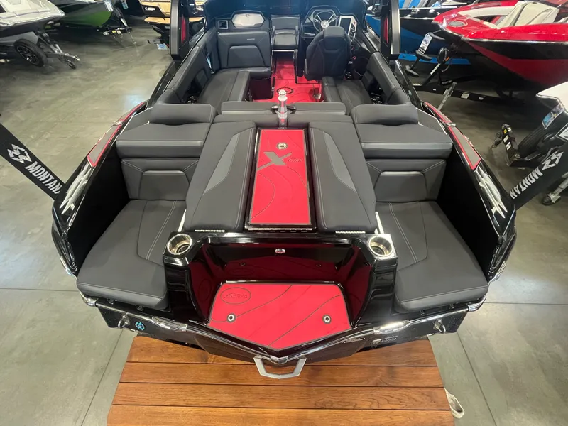 Slide: The Image of 2022 MasterCraft XStar S interior with gray seats and red flooring. - 7