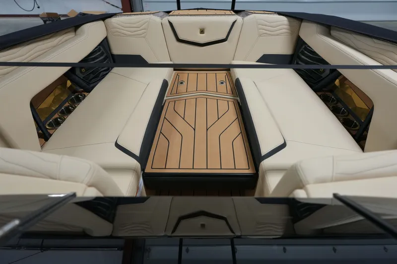 Slide: The Image of 2026 Nautique G25 interior with luxurious seating and wooden flooring. - 10