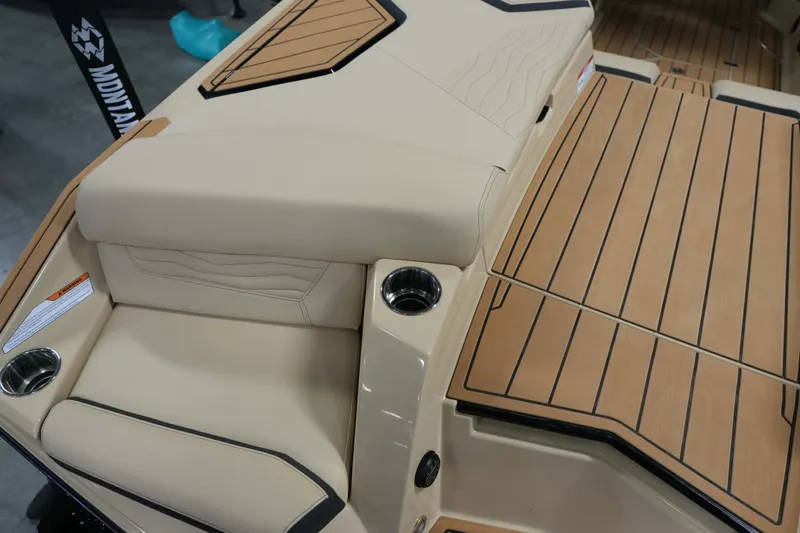 Slide: The Image of 2026 Nautique G25 interior with sleek seating and wooden flooring. - 11