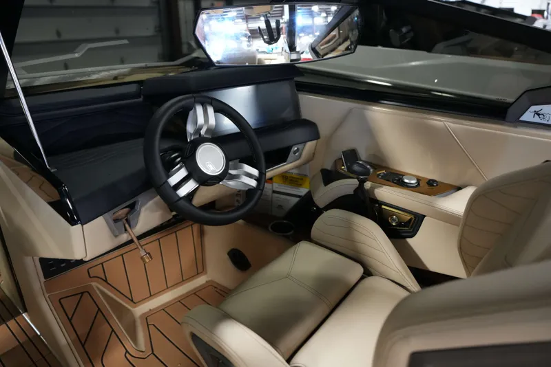 Slide: The Image of 2026 Nautique G25 interior with modern steering wheel and dashboard. - 13