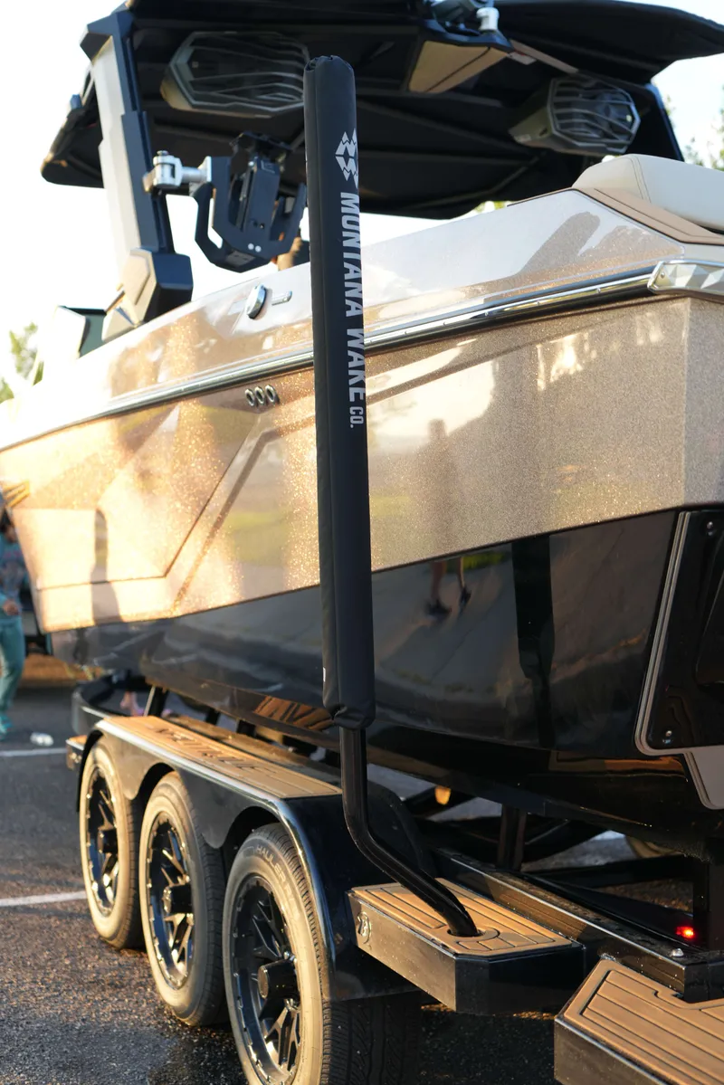 Slide: The Image of 2026 Nautique G25 boat on trailer, glossy finish. - 14