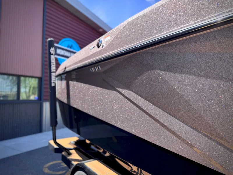 Slide: The Image of 2026 Nautique G25 boat with sparkling hull, side close-up. - 15