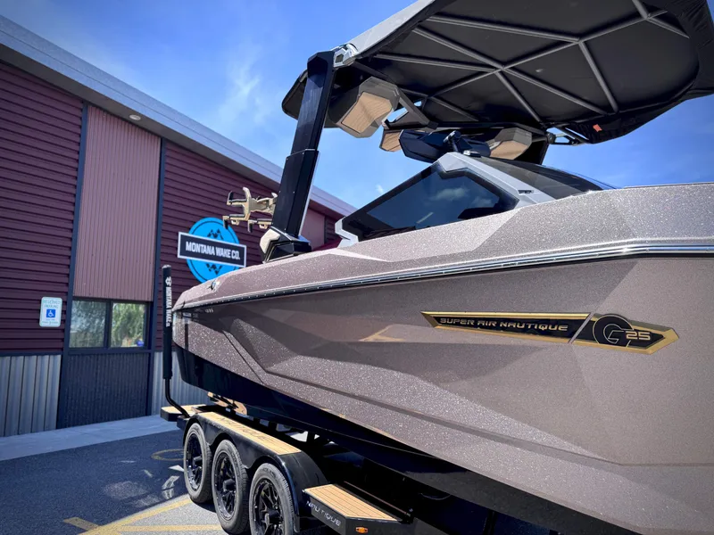 Slide: The Image of 2026 Nautique G25 boat in front of Montana Wake Co. building. - 16