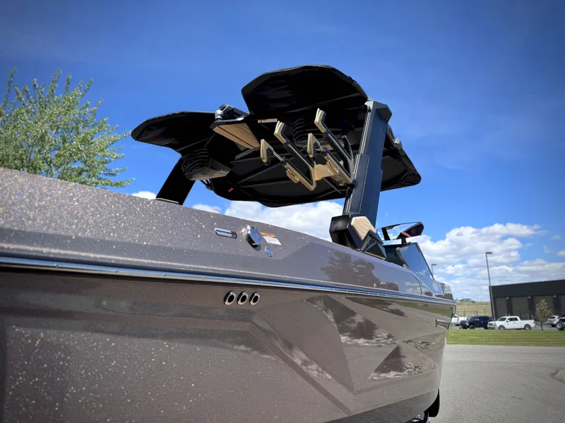Slide: The Image of 2026 Nautique G25 boat with sleek design under blue sky. - 18