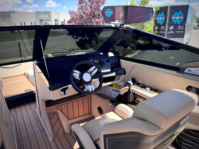 Slide: The Image of Interior of 2026 Nautique G25 with modern helm station. - 24