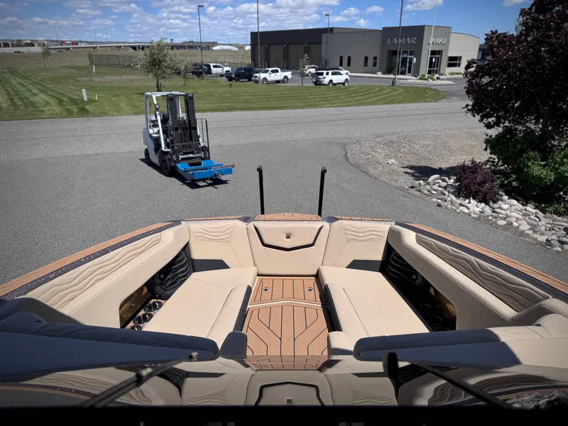 Slide: The Image of Interior view of a 2026 Nautique G25 boat with luxurious seating. - 26