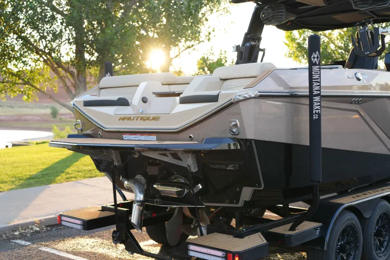 Slide: The Image of 2026 Nautique G25 boat parked at sunset. - 3