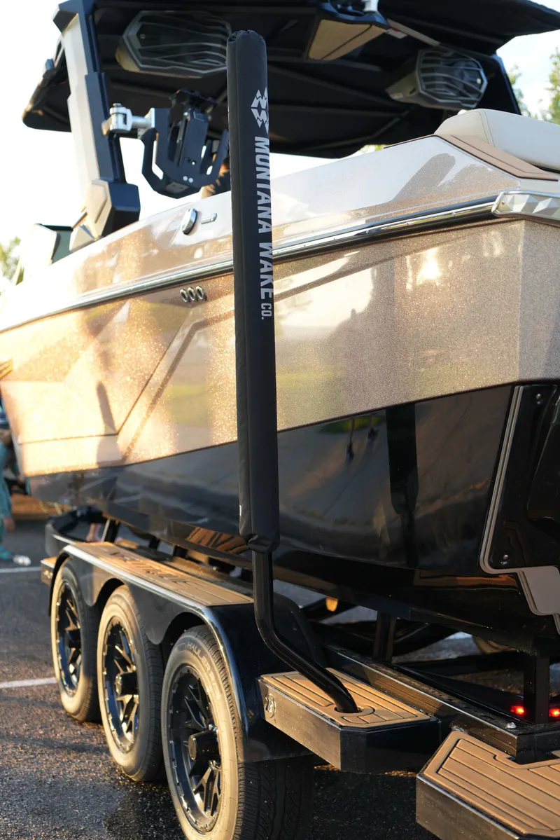 Slide: The Image of 2026 Nautique G25 boat on trailer, glossy finish, Montana Wake Co. accessory. - 4