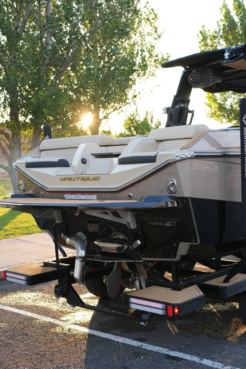 Slide: The Image of 2026 Nautique G25 boat parked at sunset. - 5