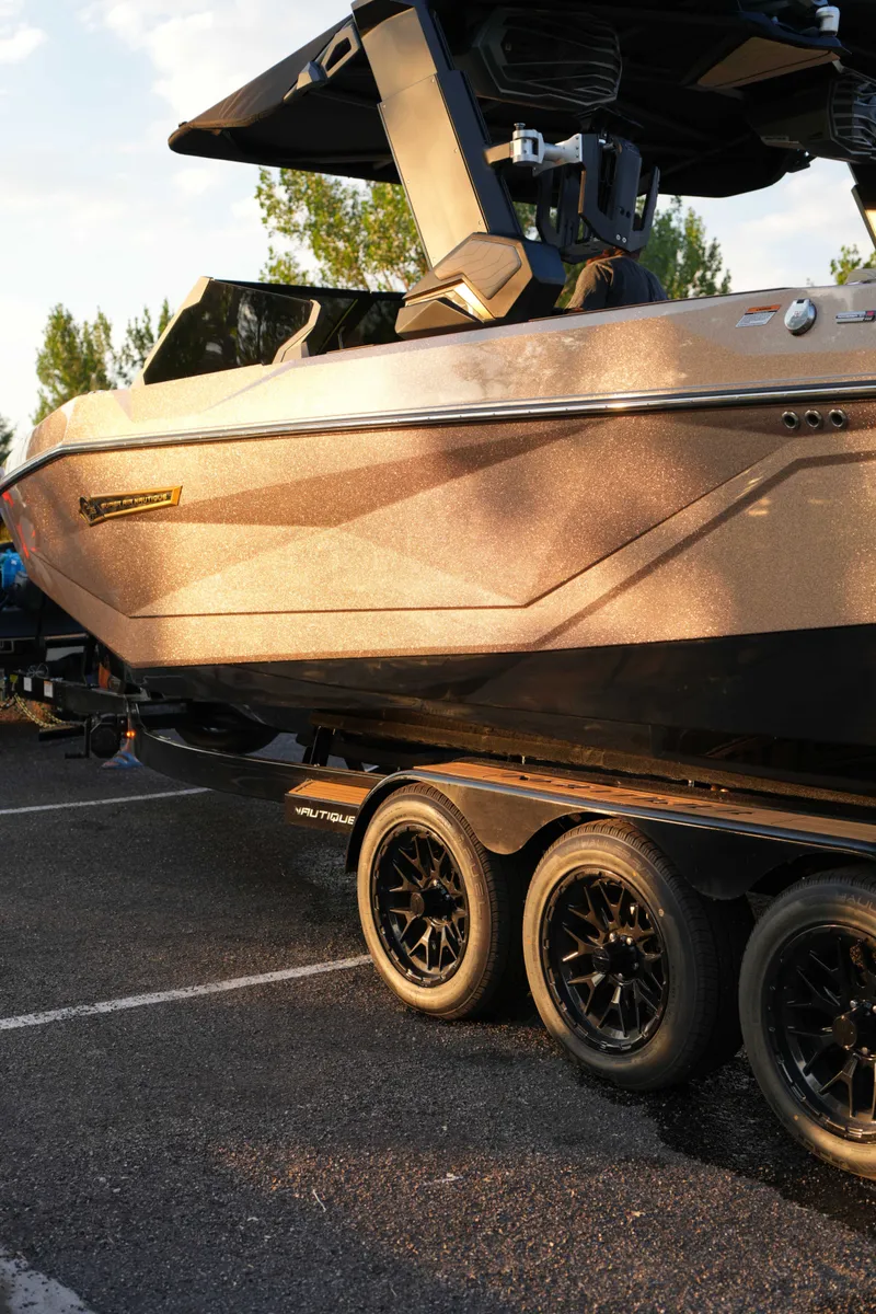 Slide: The Image of 2026 Nautique G25 boat on trailer in sunlight. - 6