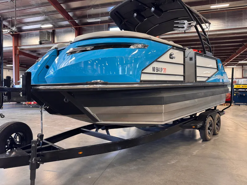 Slide: The Image of Montara Surf Boss 2.0 2021 boat on trailer in warehouse. - 2