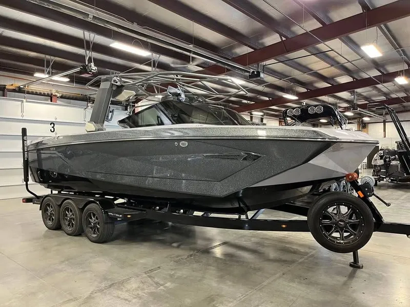 The Image of 2023 Nautique G25 boat on trailer in warehouse. - 1