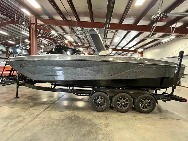 Slide: The Image of 2023 Nautique G25 boat in warehouse on trailer. - 3